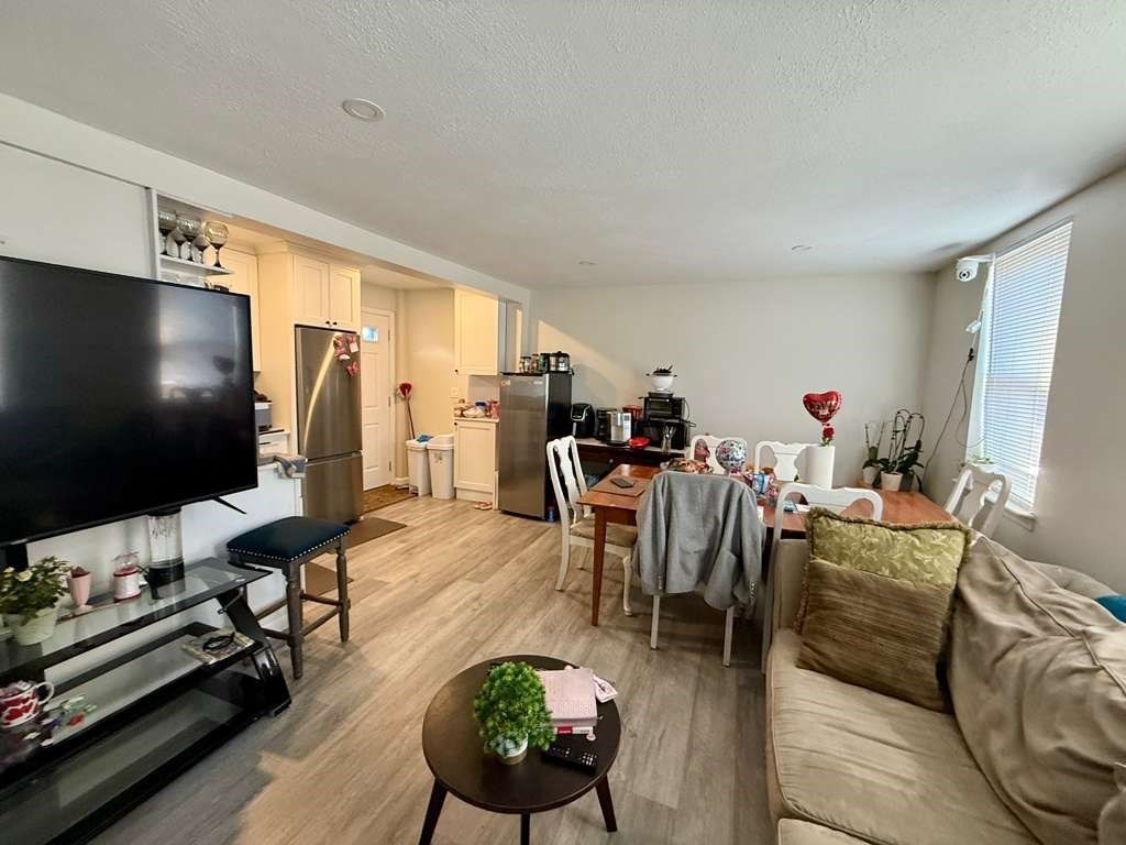 98 School Street Lowell, MA 01854 - Photo 28 of 40 a living room with furniture and a flat screen tv