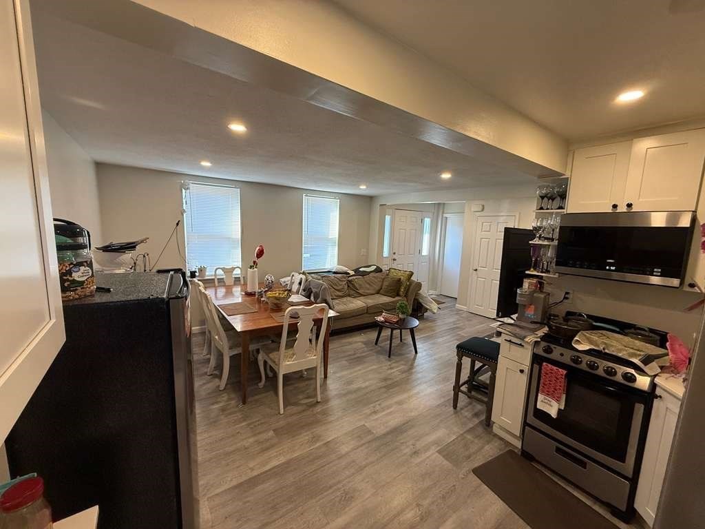 98 School Street Lowell, MA 01854 - Photo 31 of 40 a view of a dining room with furniture and wooden floor