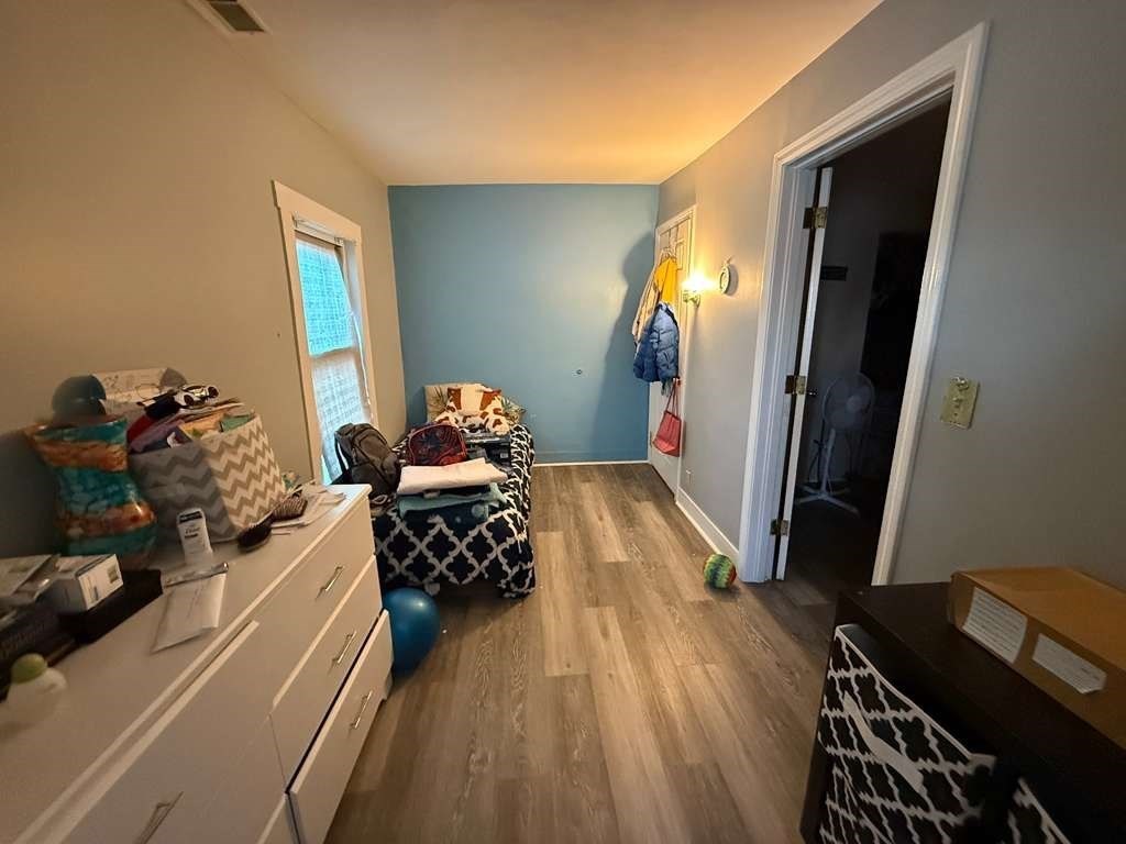 98 School Street Lowell, MA 01854 - Photo 5 of 40 a bedroom with furniture and a window