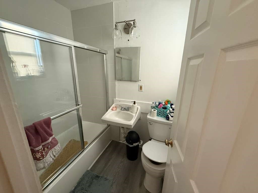 98 School Street Lowell, MA 01854 - Photo 8 of 40 a bathroom with a sink toilet and shower