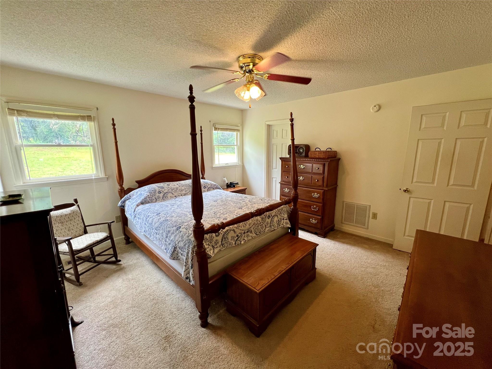 1469 Pearidge Road Bostic, NC 28018 - Photo 29 of 35 a bedroom with a bed and a chandelier