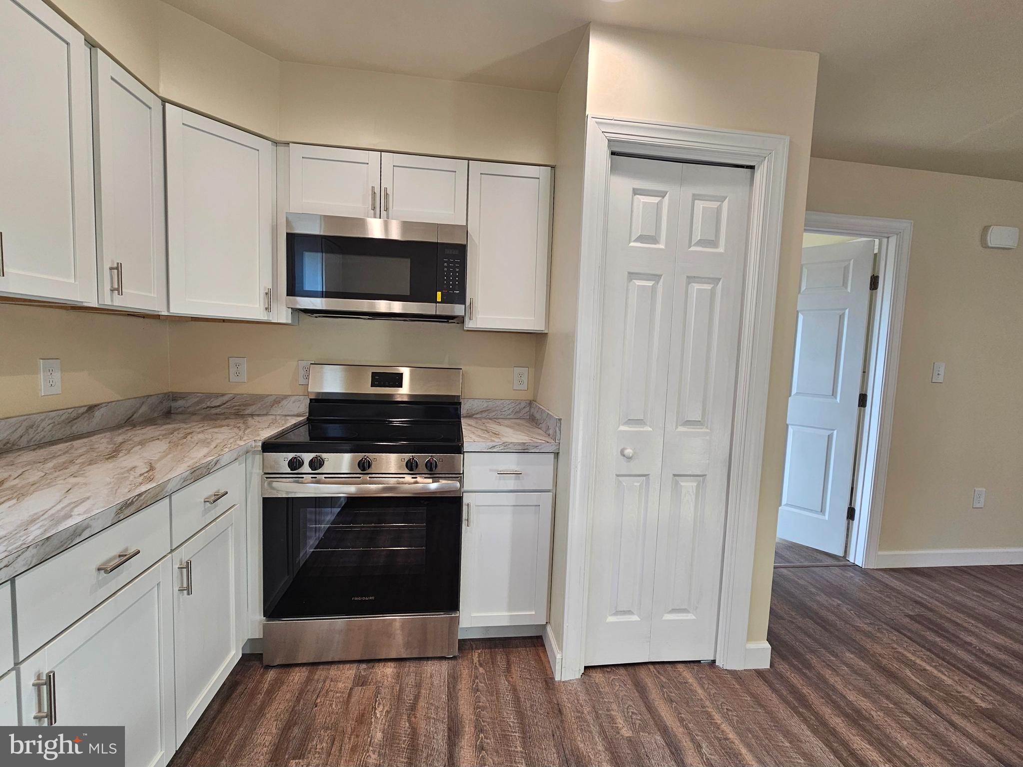 26404 Franklin Road Crisfield, MD 21817 - Photo 8 of 31 a kitchen with stainless steel appliances granite countertop a stove a sink and a refrigerator