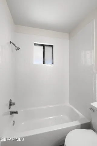 a bathroom with a bathtub and toilet
