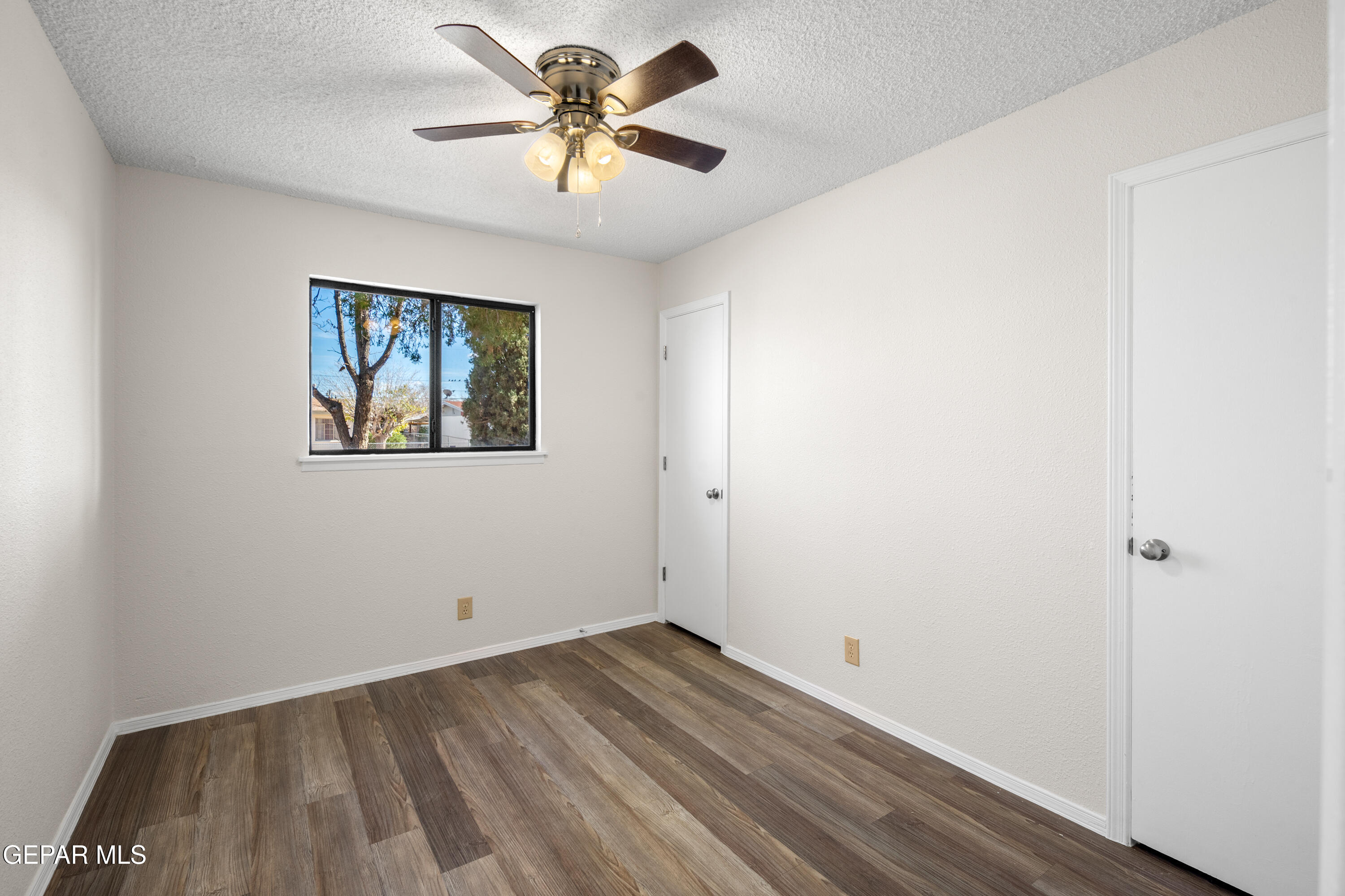 10341 Whyburn Street El Paso, TX 79924 - Photo 14 of 22 an empty room with a window and a ceiling fan