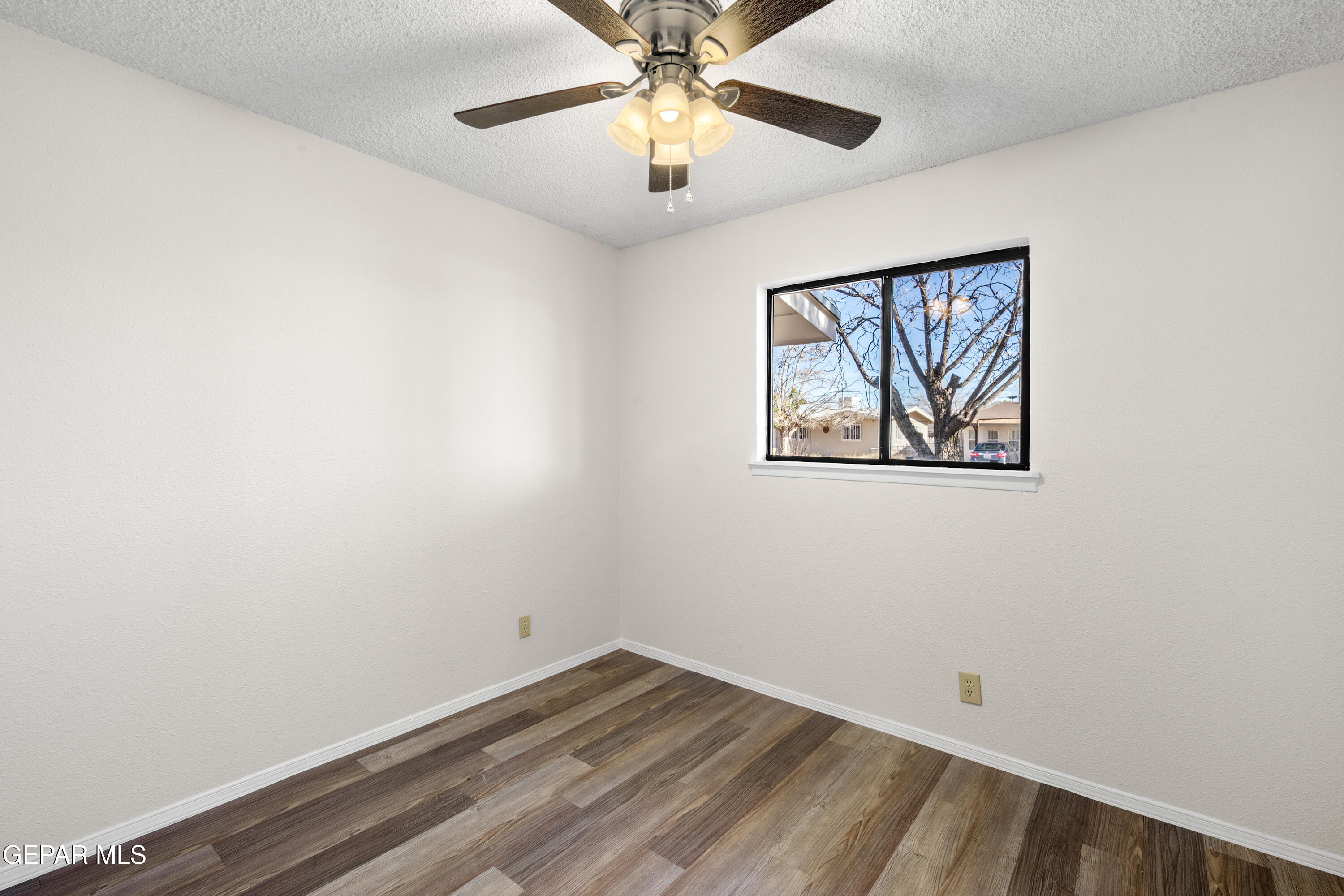 10341 Whyburn Street El Paso, TX 79924 - Photo 16 of 22 a view of empty room with wooden floor