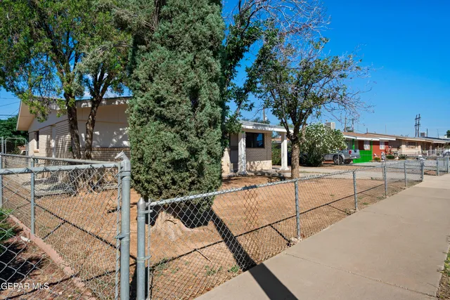 a view of a backyard with sitting area
