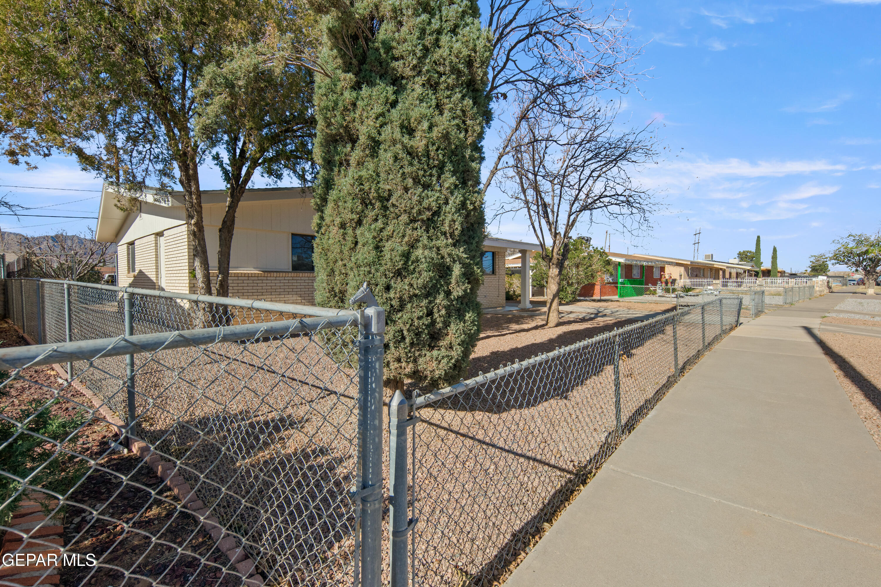 10341 Whyburn Street El Paso, TX 79924 - Photo 5 of 22 a view of a pathway with a wrought fence