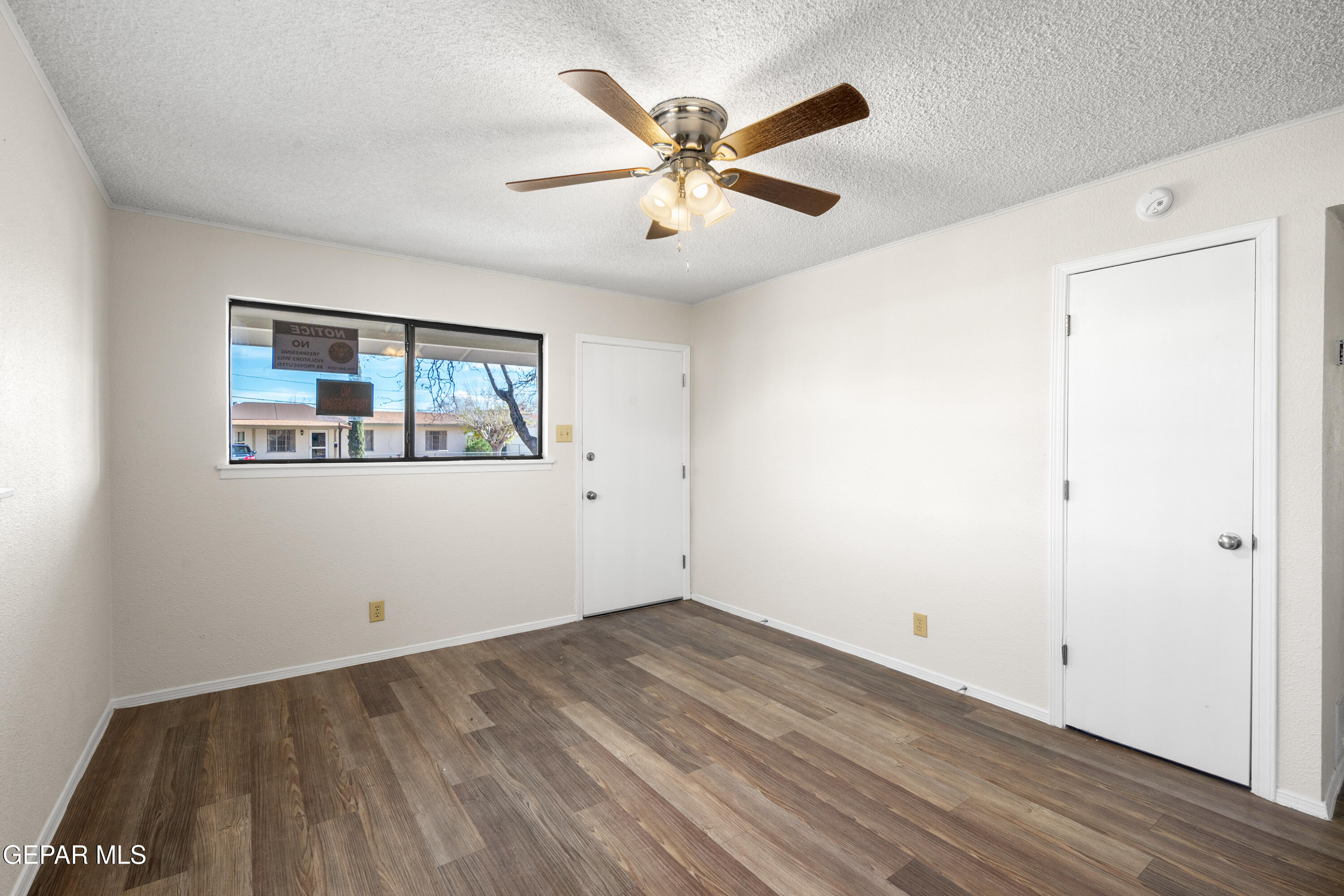 10341 Whyburn Street El Paso, TX 79924 - Photo 7 of 22 an empty room with wooden floor and ceiling fan