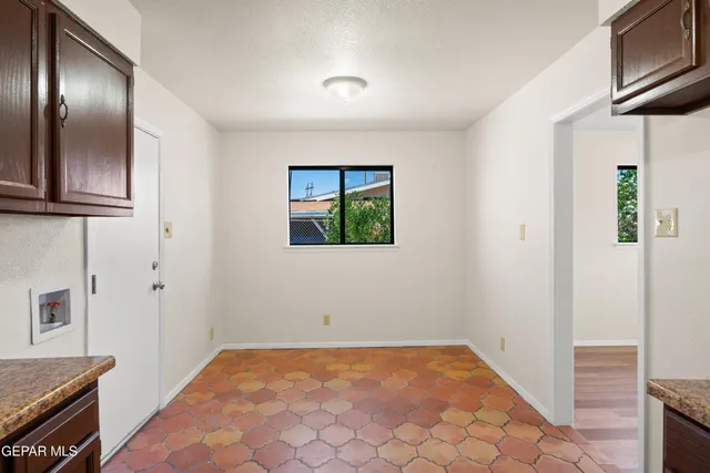 a view of a livingroom with wooden floor and staircase