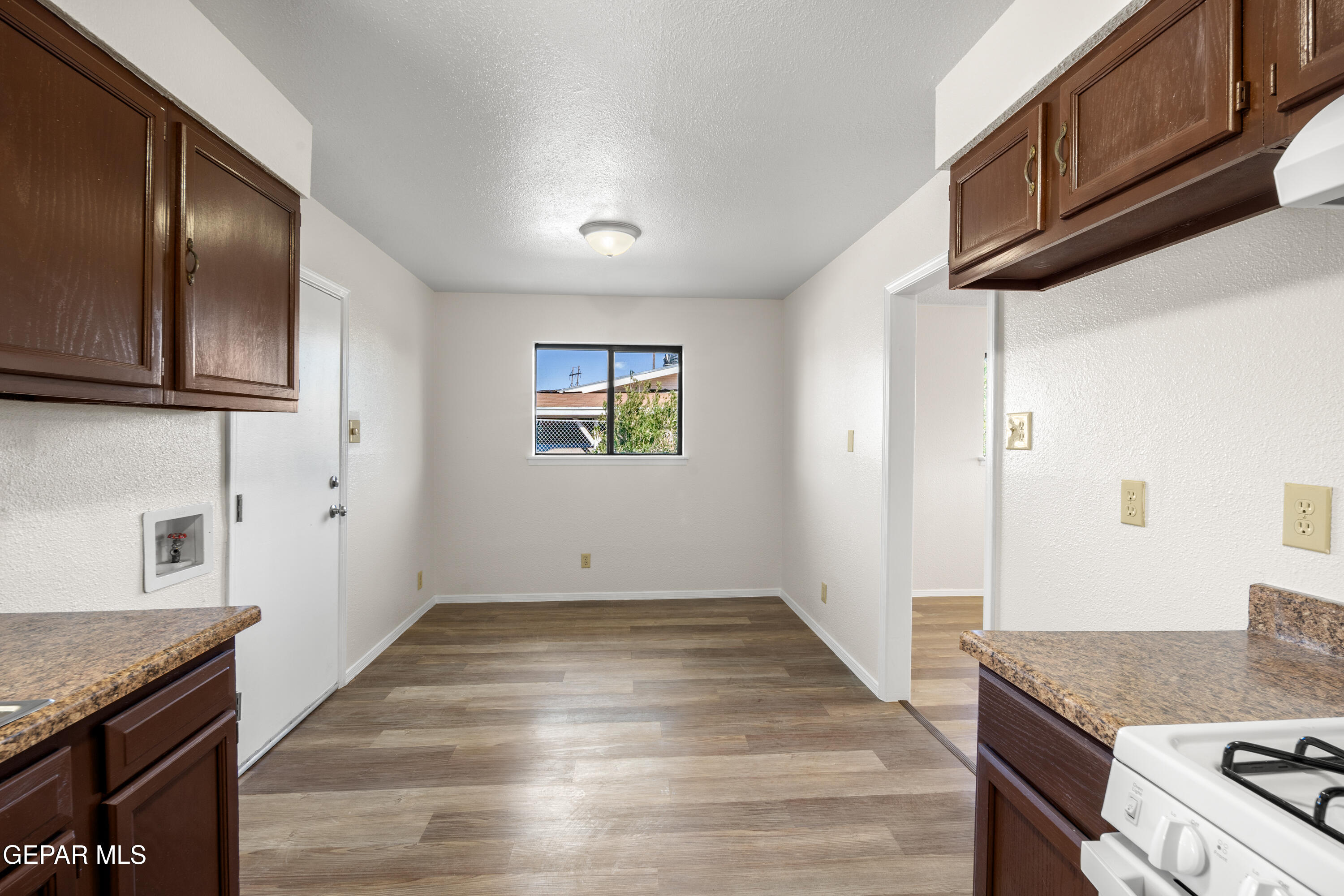 10341 Whyburn Street El Paso, TX 79924 - Photo 9 of 22 a kitchen with granite countertop wooden cabinets and granite counter tops