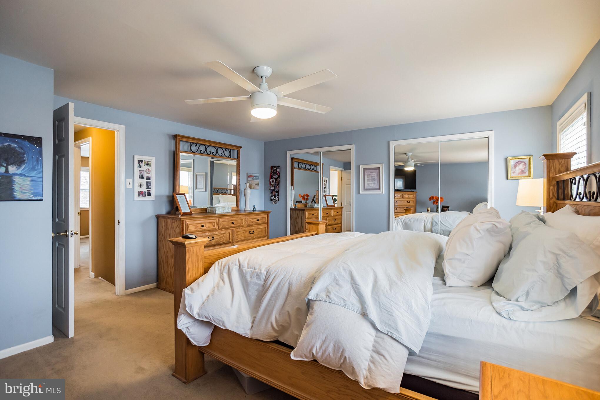 12817 Cabell Road Philadelphia, PA 19154 - Photo 12 of 30 a bedroom with a large bed and a chandelier