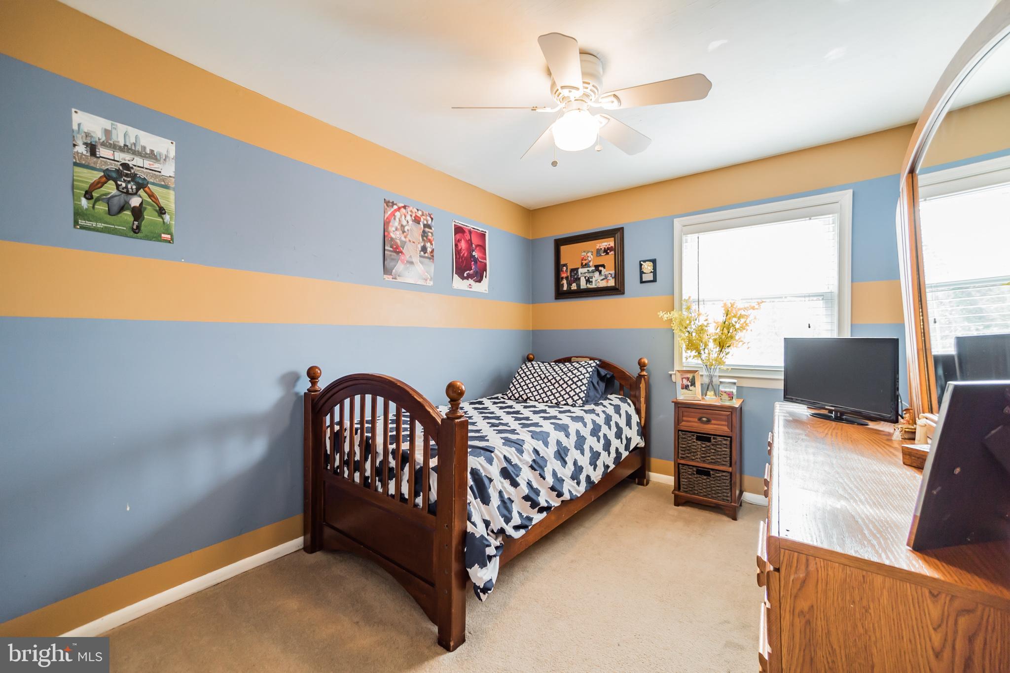 12817 Cabell Road Philadelphia, PA 19154 - Photo 15 of 30 a bedroom with a bed and a chandelier