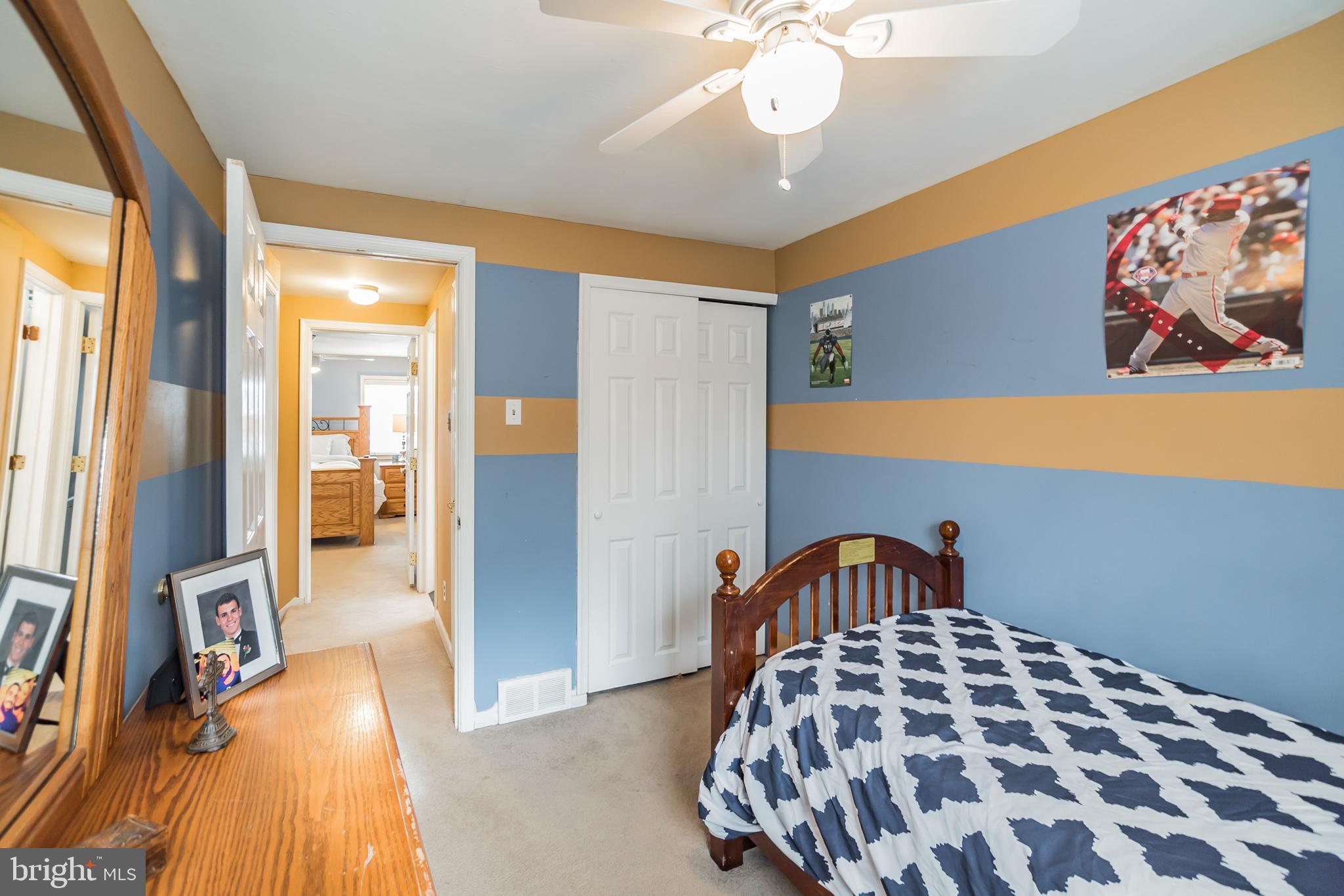 12817 Cabell Road Philadelphia, PA 19154 - Photo 16 of 30 a bedroom with a bed and a chandelier