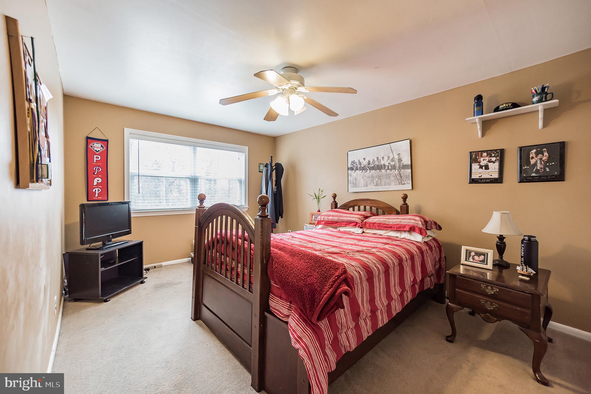 12817 Cabell Road Philadelphia, PA 19154 - Photo 17 of 30 a bedroom with a bed and a chandelier