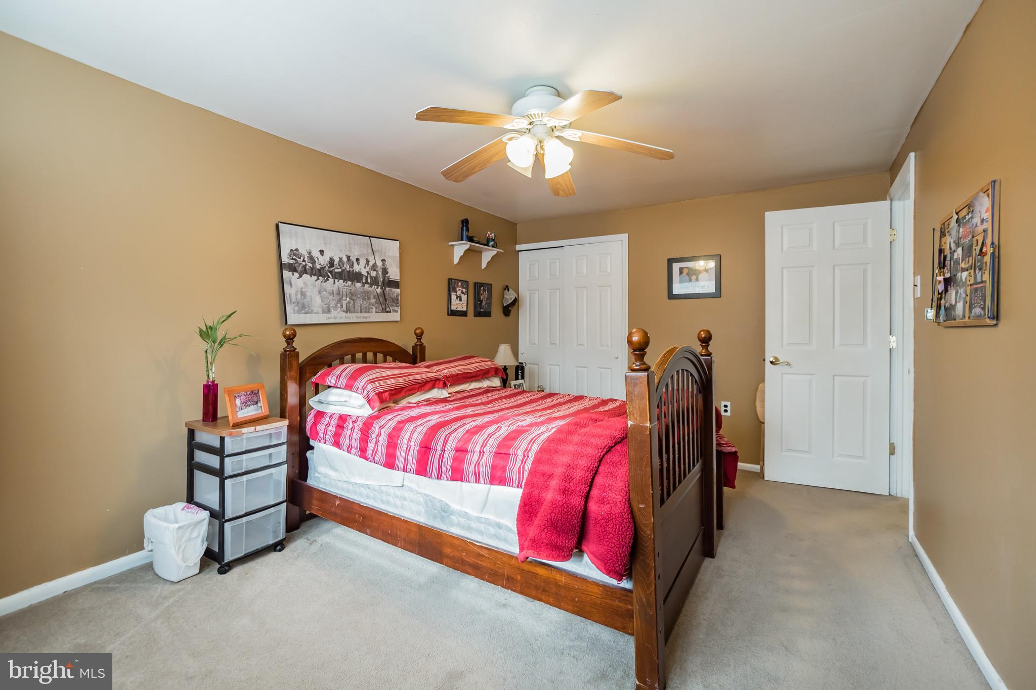 12817 Cabell Road Philadelphia, PA 19154 - Photo 18 of 30 a bedroom with a bed and a chandelier