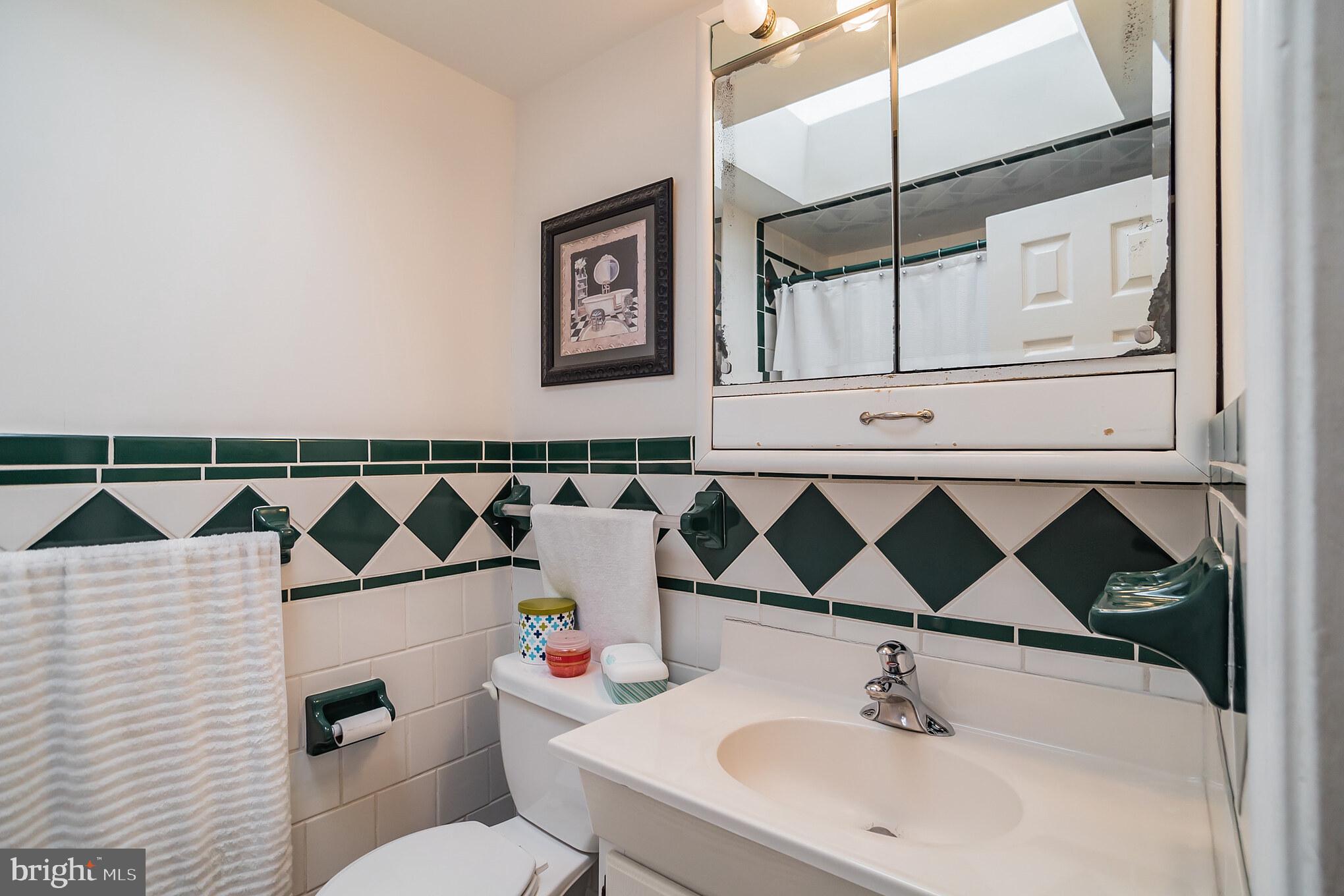 12817 Cabell Road Philadelphia, PA 19154 - Photo 19 of 30 a bathroom with a sink vanity mirror and toilet