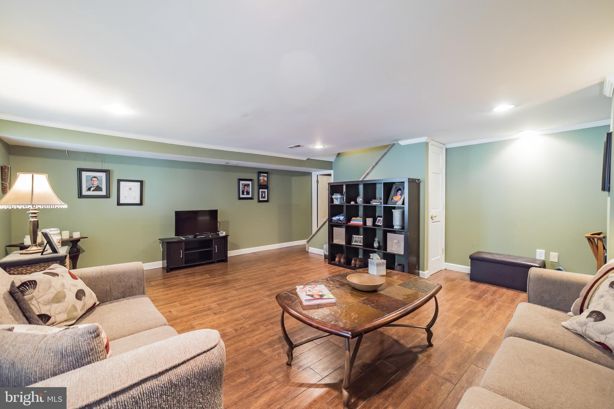 12817 Cabell Road Philadelphia, PA 19154 - Photo 21 of 30 a living room with furniture a table and a wooden floor