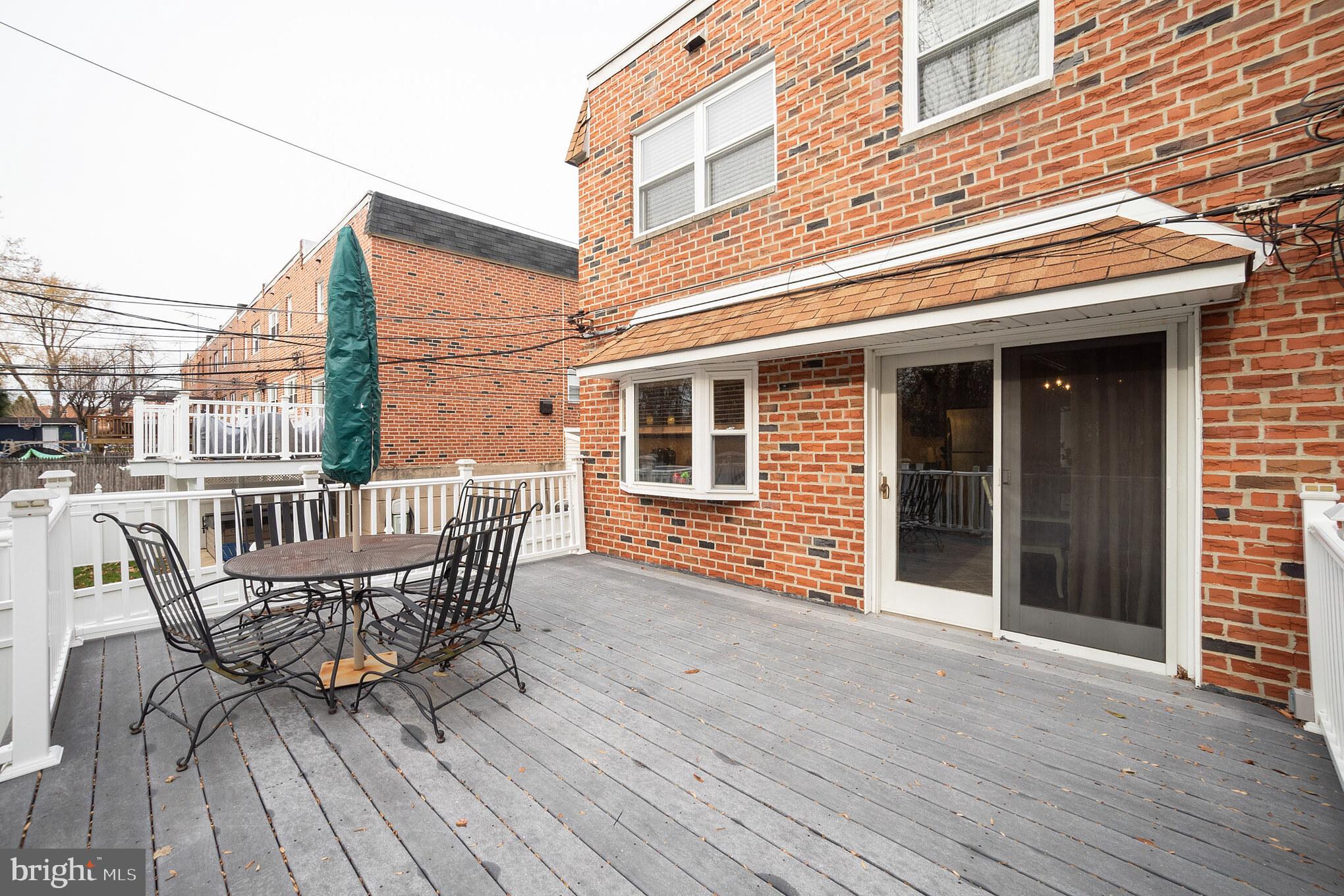 12817 Cabell Road Philadelphia, PA 19154 - Photo 30 of 30 a view of a roof deck with table and chairs and wooden floor