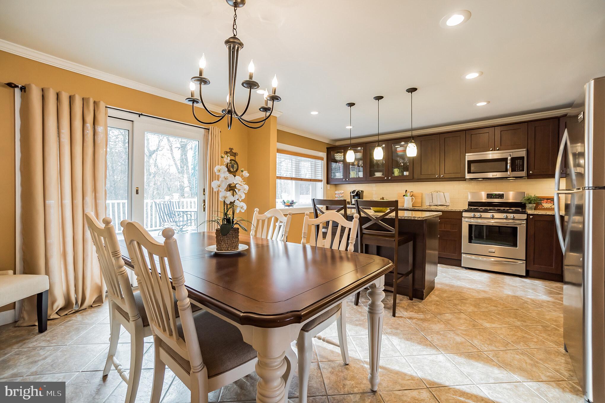 12817 Cabell Road Philadelphia, PA 19154 - Photo 7 of 30 a kitchen with stainless steel appliances granite countertop a stove kitchen island a dining table and chairs