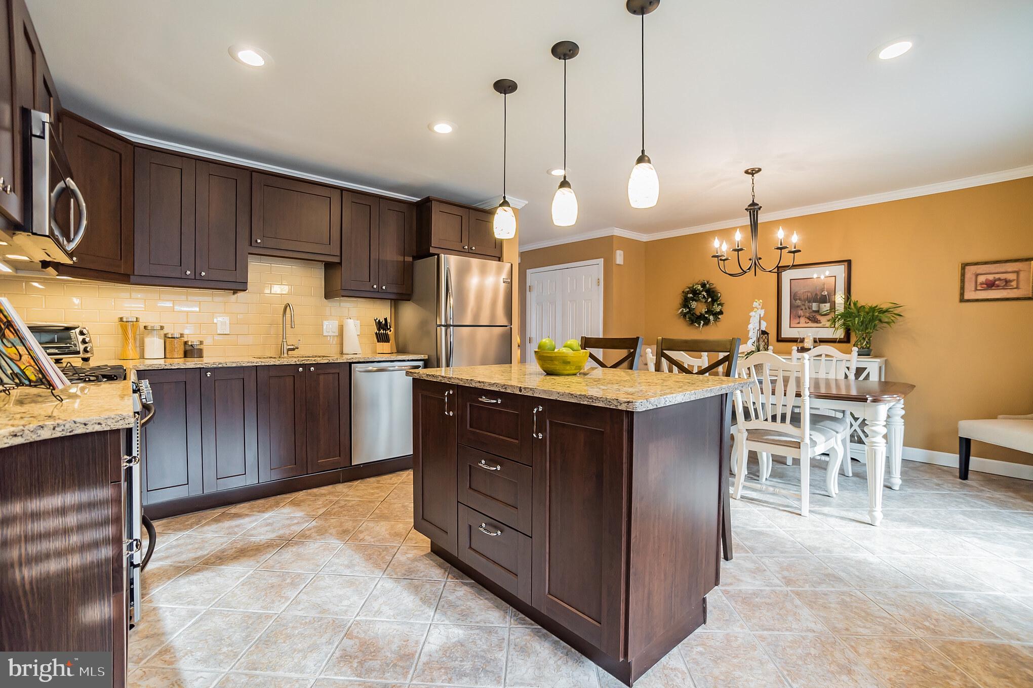 12817 Cabell Road Philadelphia, PA 19154 - Photo 9 of 30 a kitchen with a sink and chairs