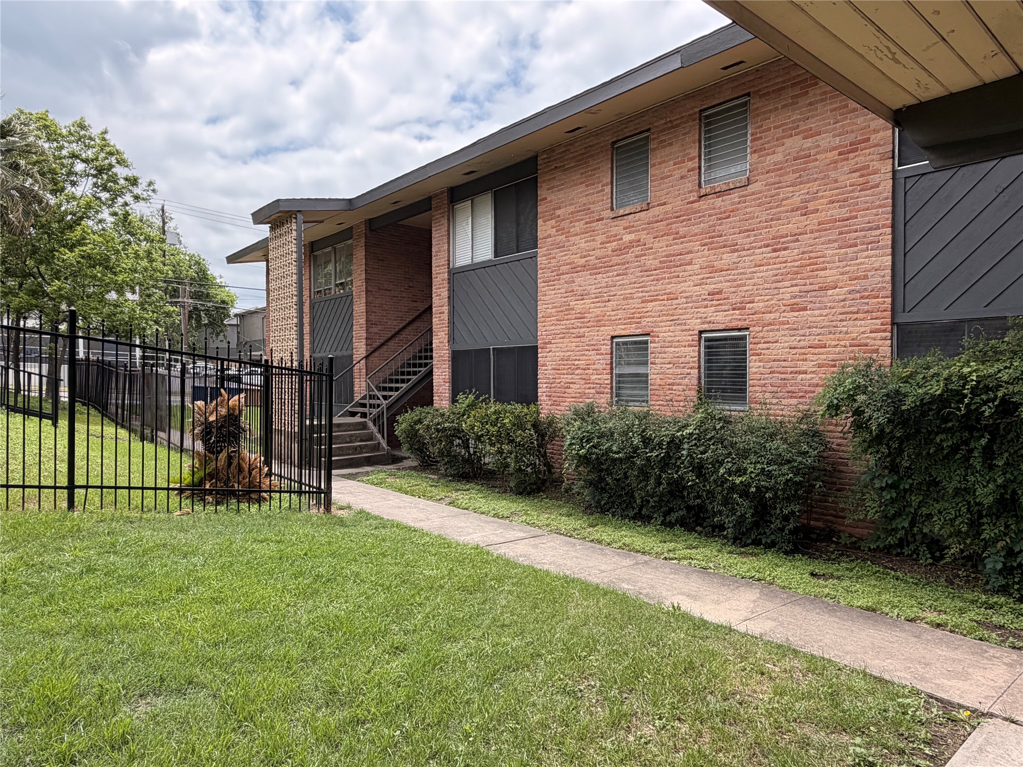 3304 Red River Street, Unit 102 Austin, TX 78705 - Photo 1 of 15 a view of a house with a yard and sitting area