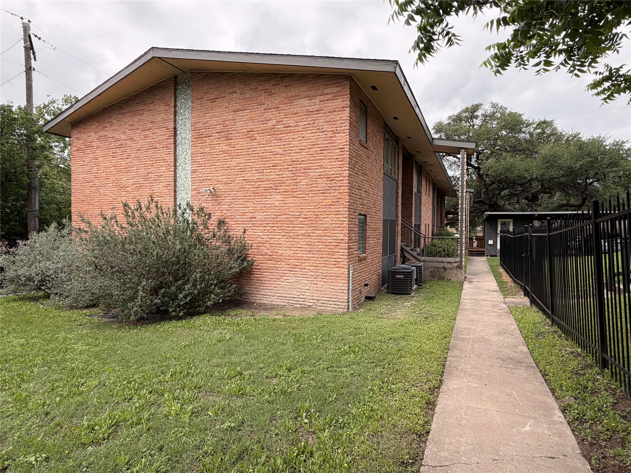 3304 Red River Street, Unit 102 Austin, TX 78705 - Photo 15 of 15 a view of a pathway with a house in the background