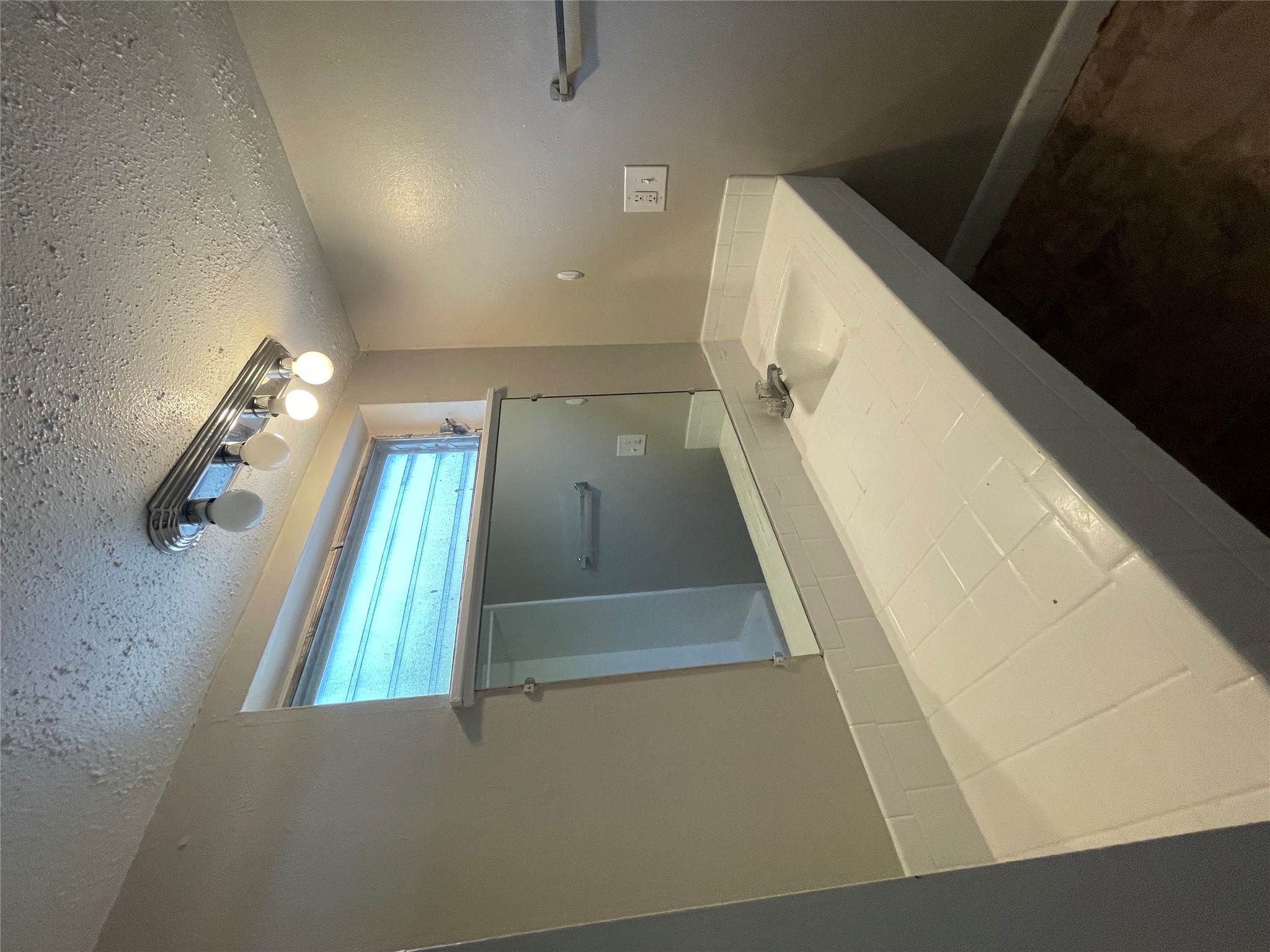 3304 Red River Street, Unit 102 Austin, TX 78705 - Photo 7 of 15 a bathroom with a sink a vanity and a mirror