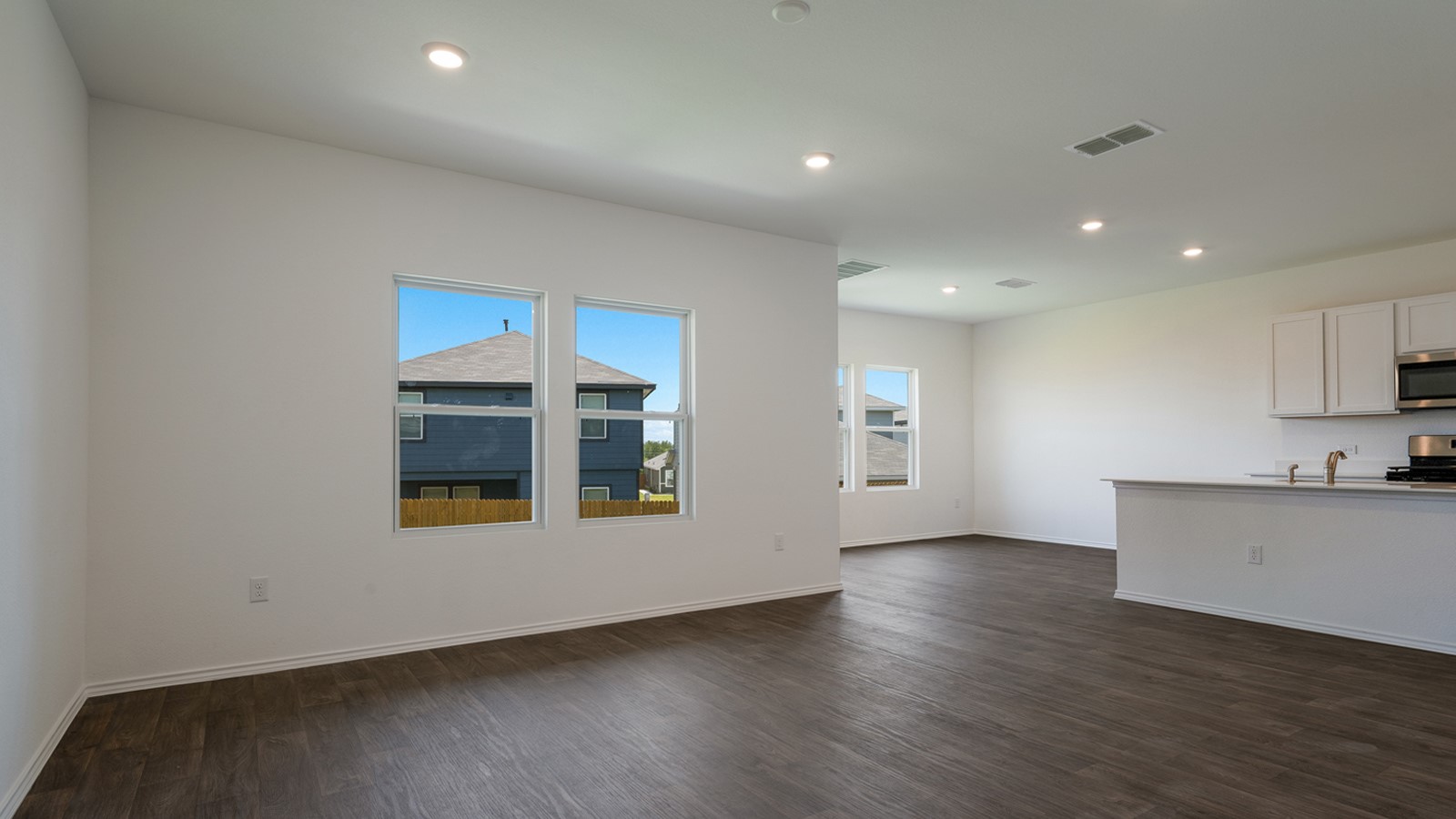 12105 Pike Bend Mustang Ridge, TX 78610 - Photo 2 of 21 a view of an empty room with wooden floor and a window