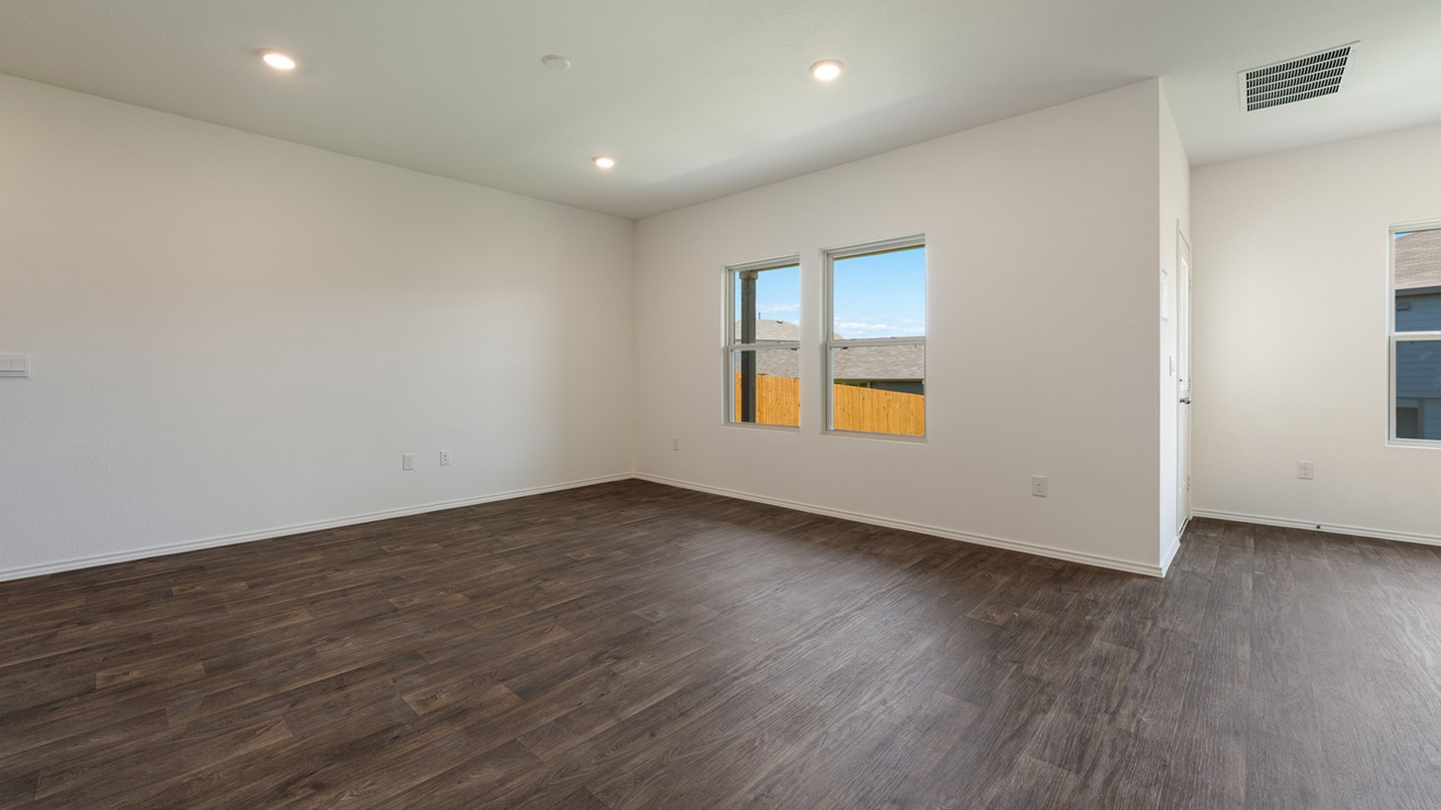 12105 Pike Bend Mustang Ridge, TX 78610 - Photo 6 of 21 an empty room with wooden floor and windows