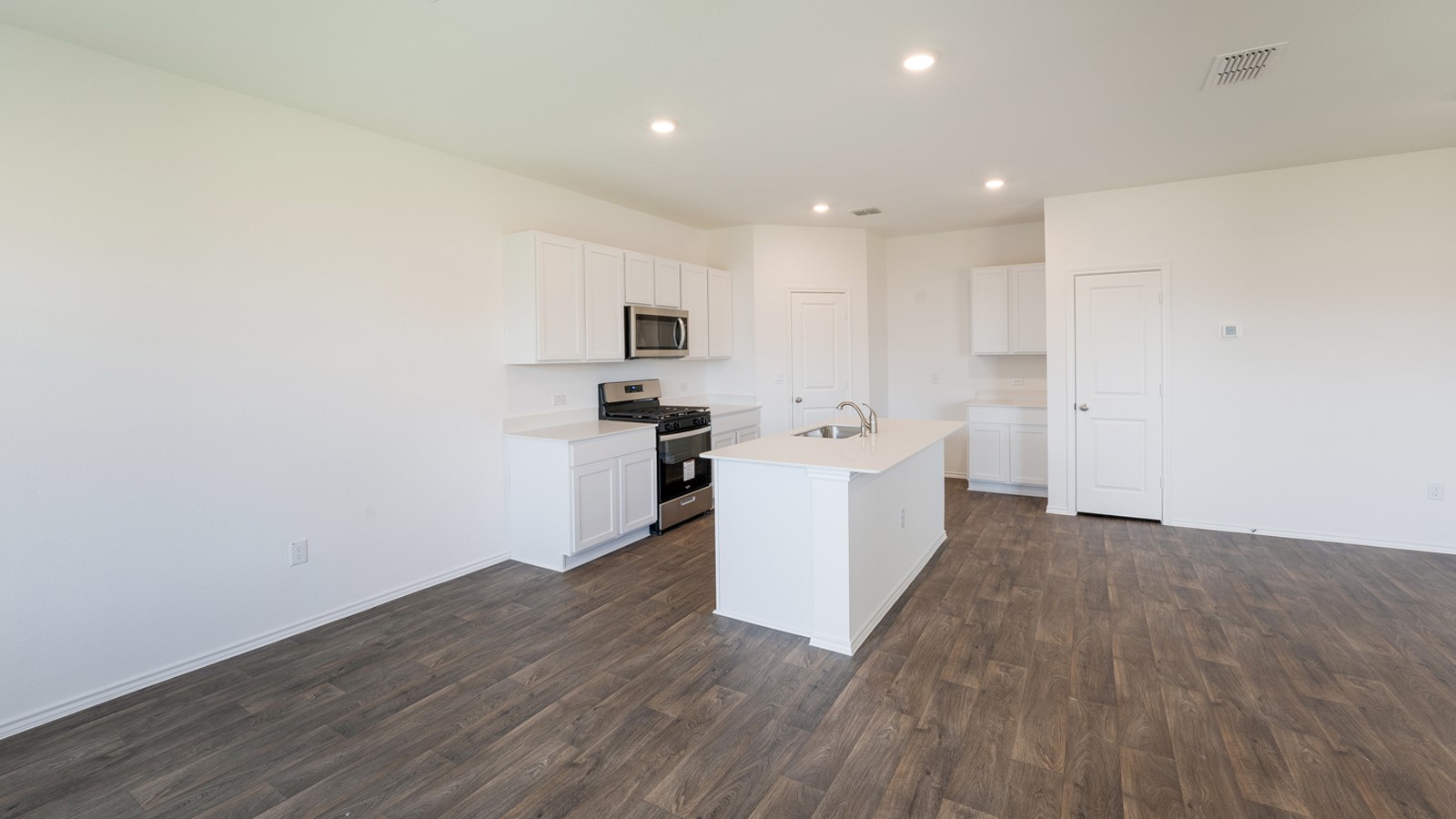 12105 Pike Bend Mustang Ridge, TX 78610 - Photo 7 of 21 a view of a kitchen with wooden floor