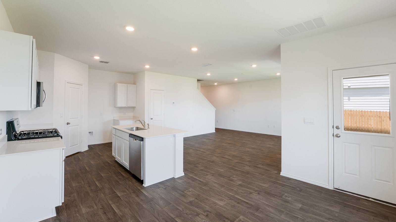 12105 Pike Bend Mustang Ridge, TX 78610 - Photo 8 of 21 a kitchen with stainless steel appliances granite countertop a stove a sink and a refrigerator