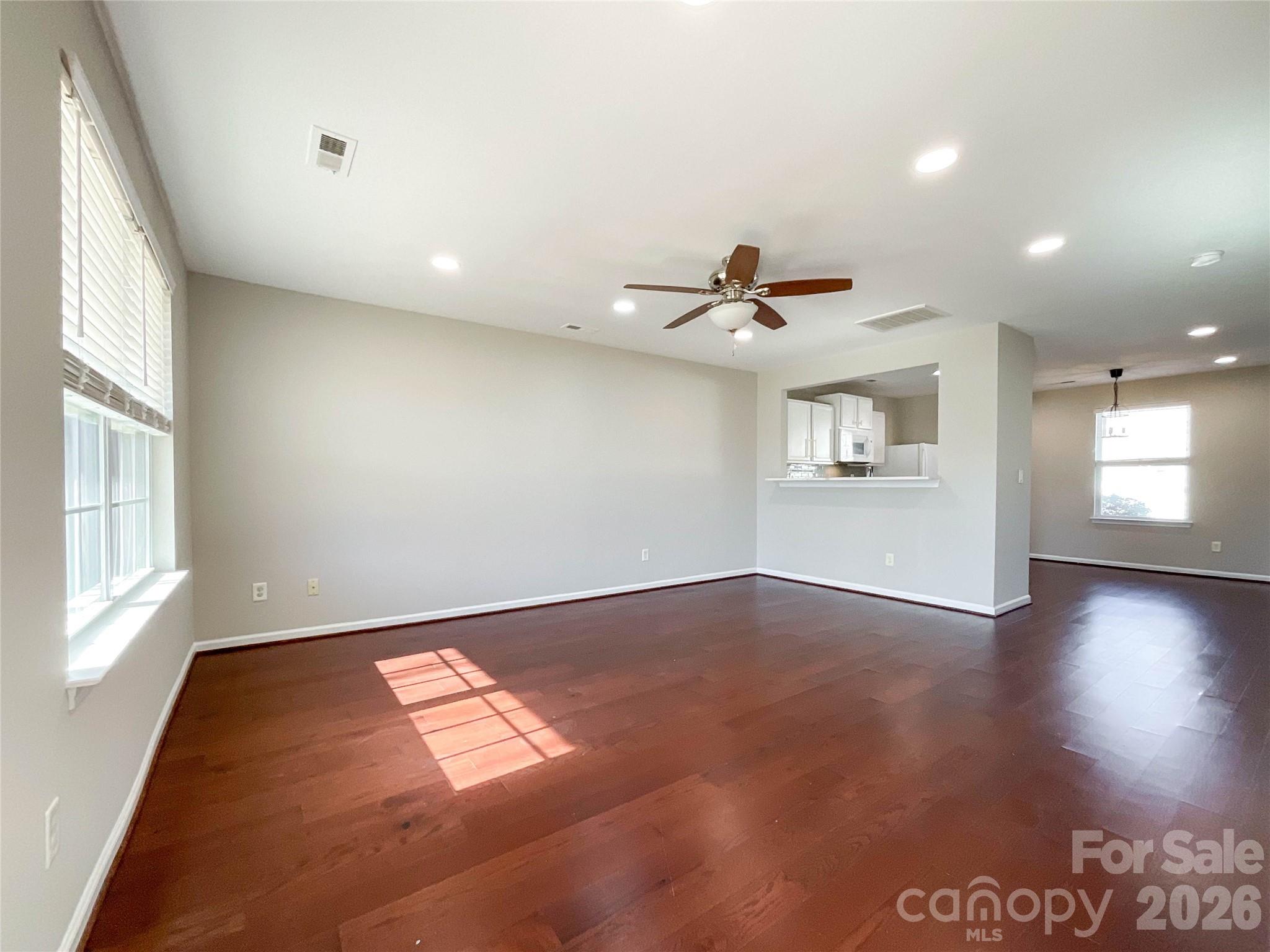 301 Foster Lane Albemarle, NC 28001 - Photo 11 of 41 an empty room with wooden floor and windows