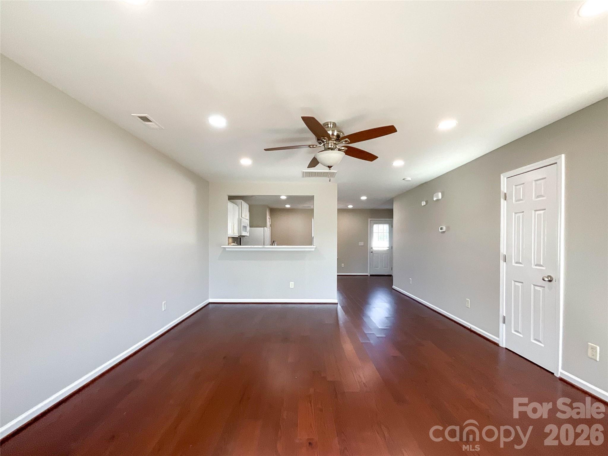 301 Foster Lane Albemarle, NC 28001 - Photo 13 of 41 an empty room with wooden floor and windows
