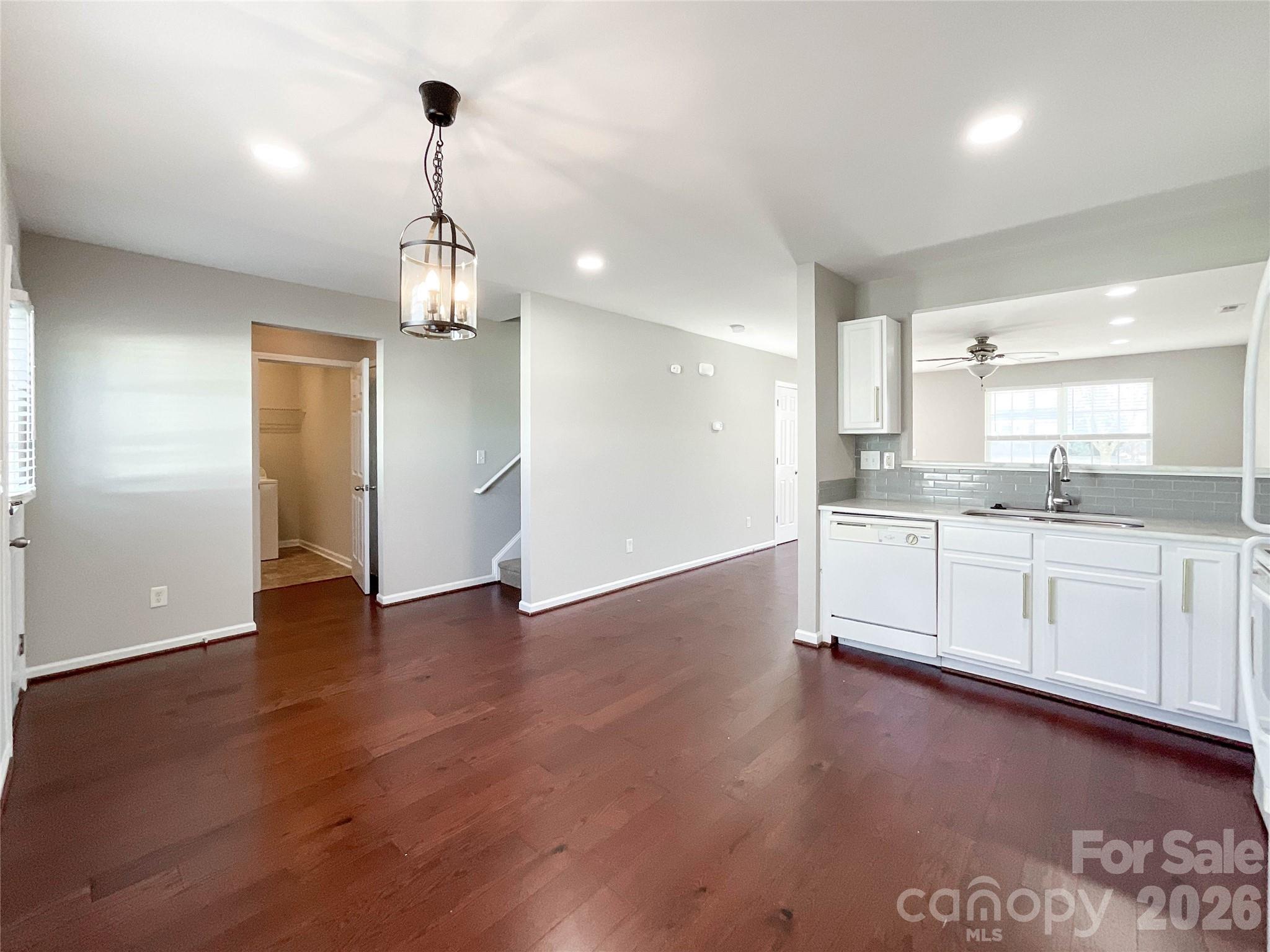 301 Foster Lane Albemarle, NC 28001 - Photo 16 of 41 a view of a kitchen with a sink and dishwasher a refrigerator with wooden floor