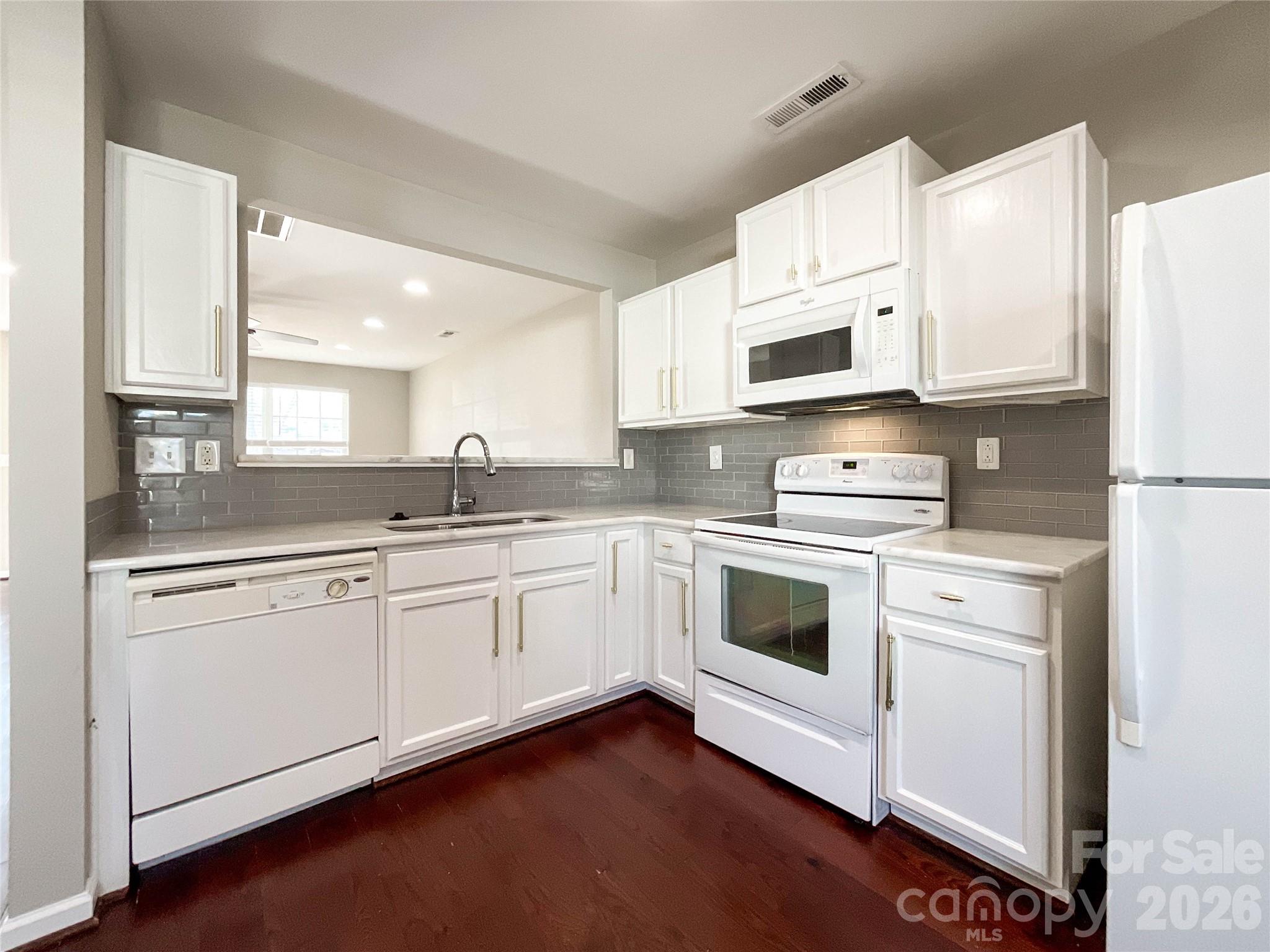 301 Foster Lane Albemarle, NC 28001 - Photo 17 of 41 a kitchen with granite countertop white cabinets and white appliances