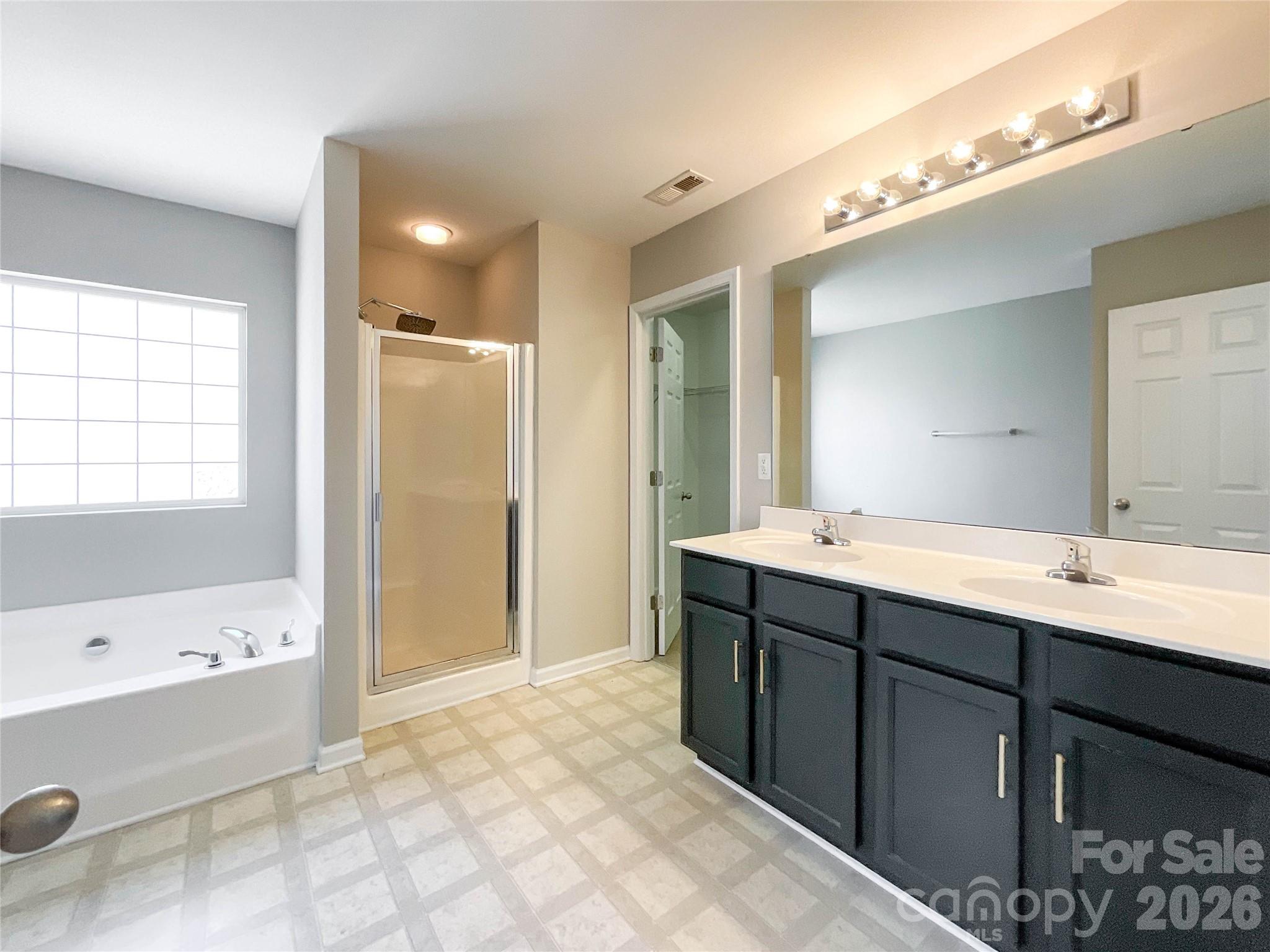 301 Foster Lane Albemarle, NC 28001 - Photo 25 of 41 a bathroom with a tub a sink shower and mirror