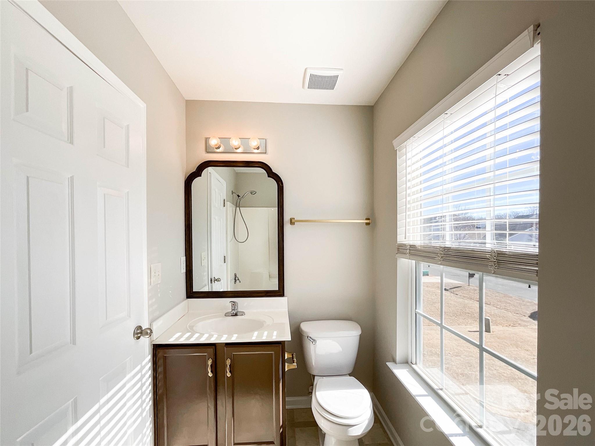 301 Foster Lane Albemarle, NC 28001 - Photo 34 of 41 a bathroom with a toilet sink and mirror