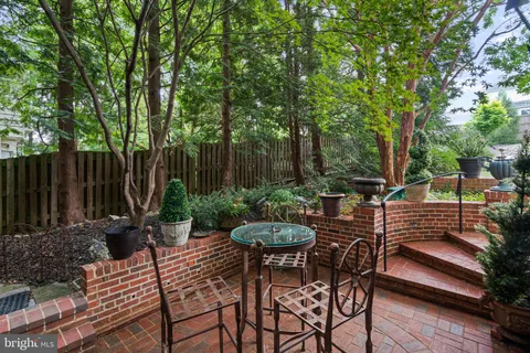 a view of a chairs and tables in the backyard