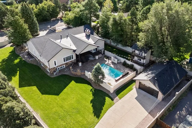 an aerial view of a house with pool patio and outdoor seating