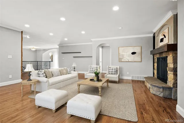 a living room with furniture and wooden floor