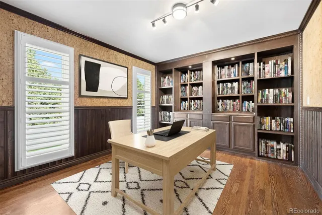 a workspace with furniture bookshelf and a window