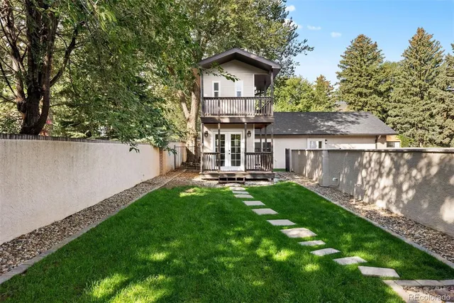 a view of backyard with deck and garden