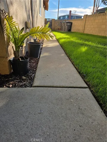 a view of a porch with furniture and a yard