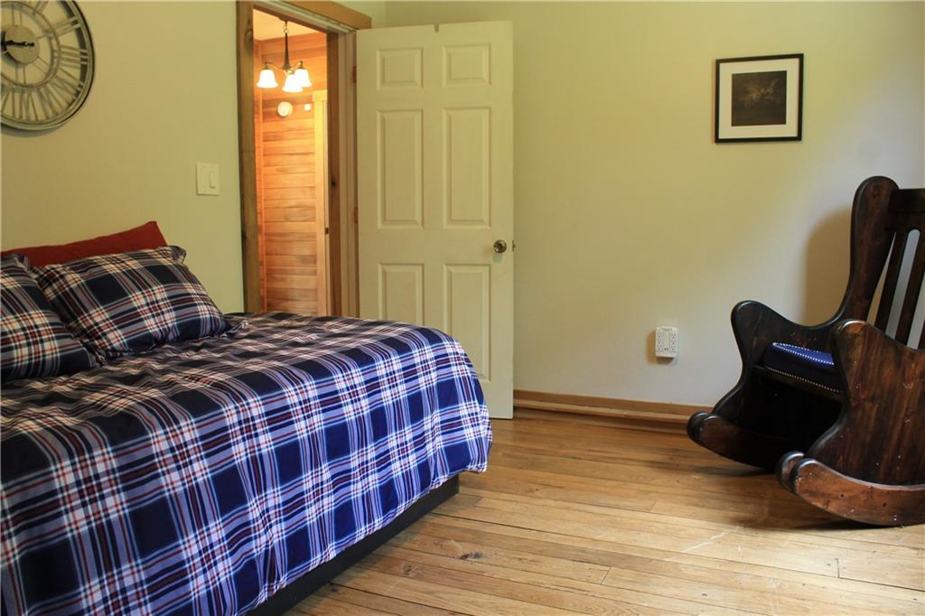 401 Bear Rocks Road Acme, PA 15610 - Photo 18 of 25 a bedroom with a bed and wooden floor