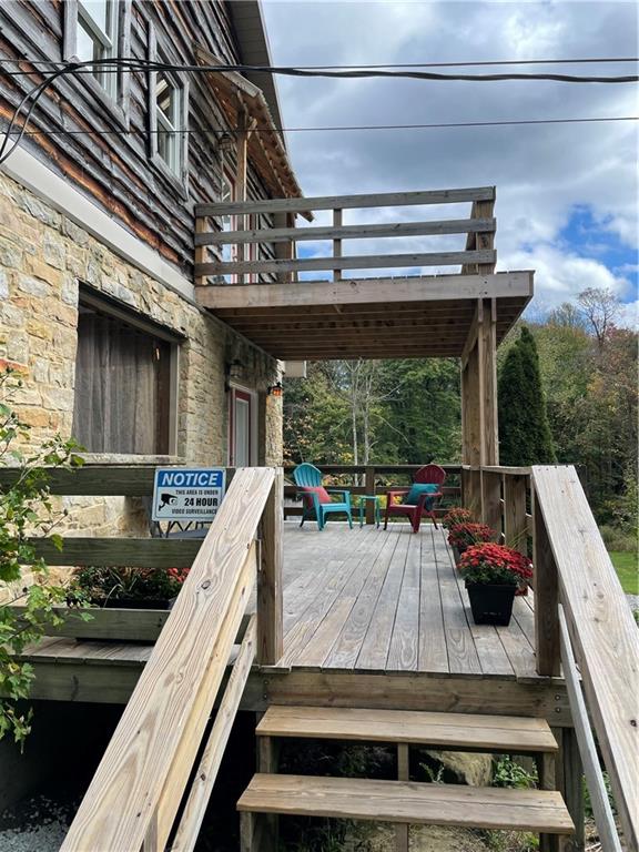 401 Bear Rocks Road Acme, PA 15610 - Photo 20 of 25 a view of a patio with a table and chairs
