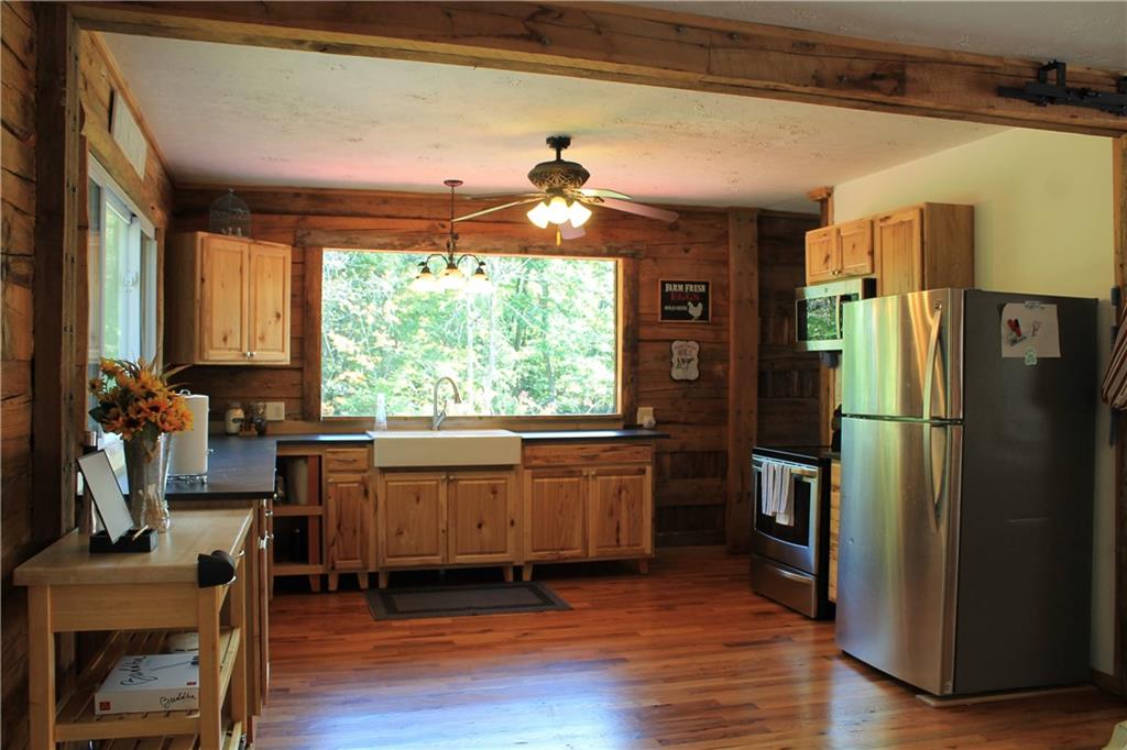 401 Bear Rocks Road Acme, PA 15610 - Photo 4 of 25 a kitchen with granite countertop wooden floors appliances and furniture