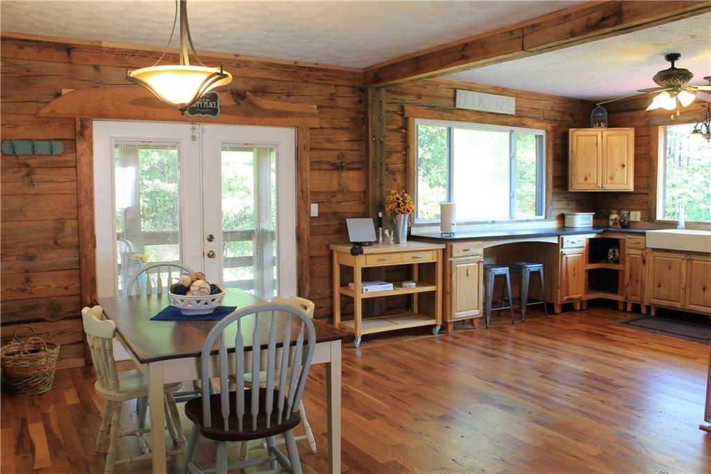 401 Bear Rocks Road Acme, PA 15610 - Photo 5 of 25 a room with stainless steel appliances kitchen island granite countertop a stove a refrigerator a dining table and chairs with wooden floor
