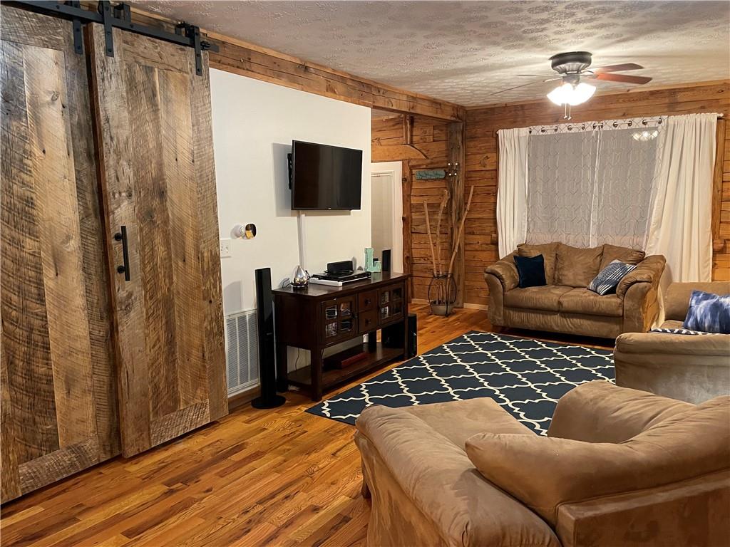 401 Bear Rocks Road Acme, PA 15610 - Photo 7 of 25 a living room with furniture and a flat screen tv