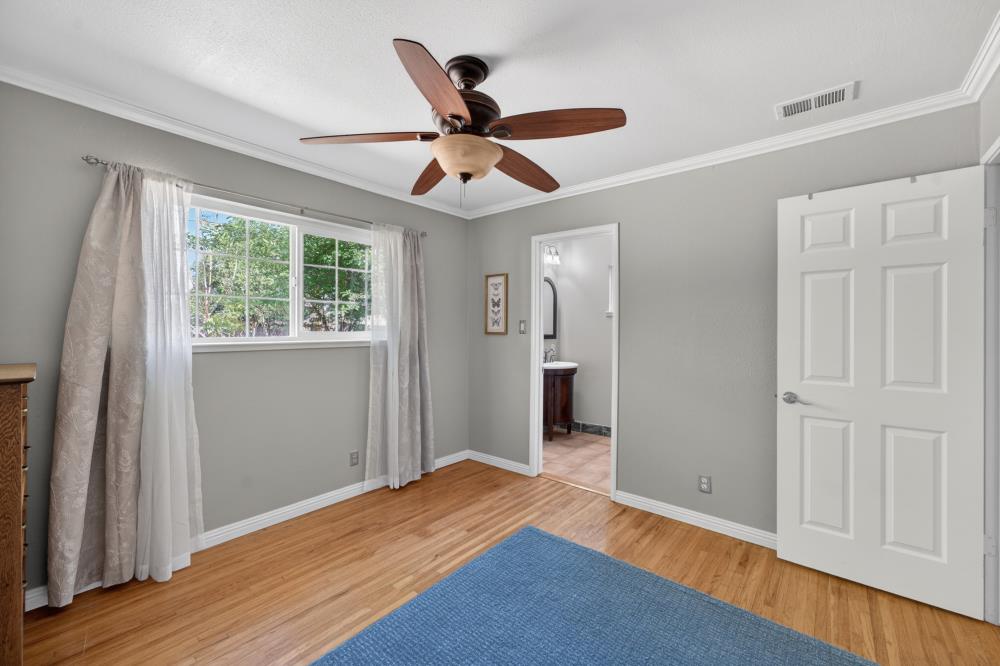 10653 Campana Way Rancho Cordova, CA 95670 - Photo 33 of 49 a bedroom with wooden floor a ceiling fan and a window