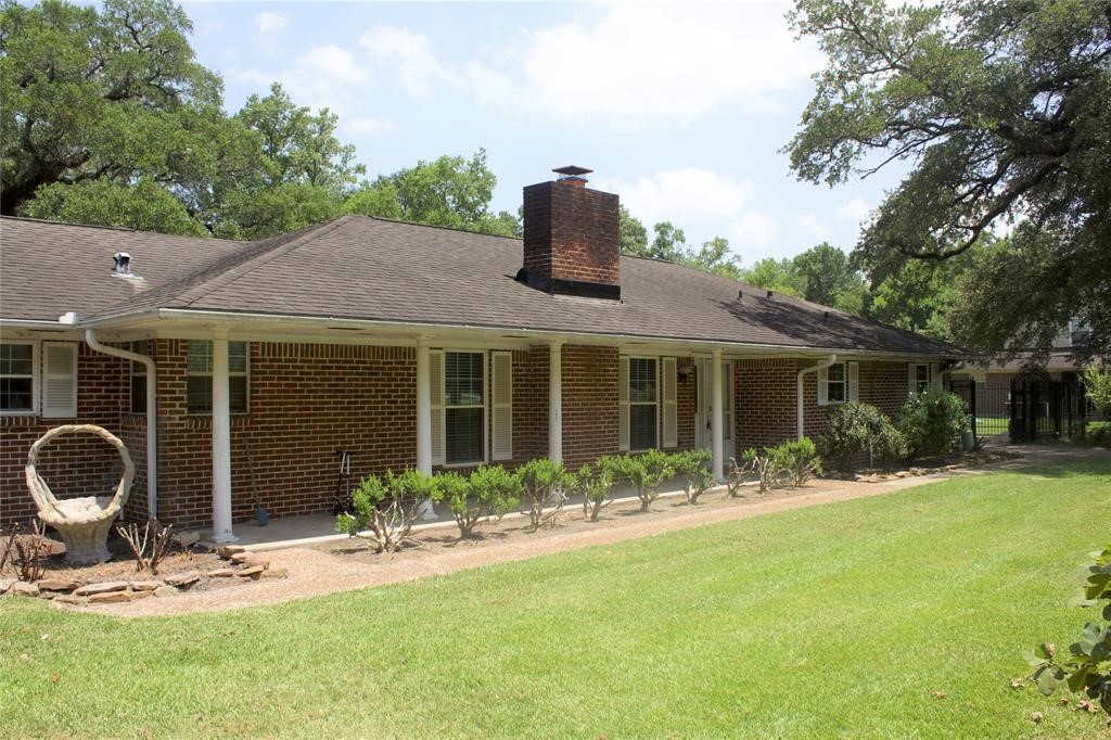 10702 Crosby Lynchburg Road Highlands, TX 77562 - Photo 2 of 18 a front view of house with yard outdoor seating and barbeque oven